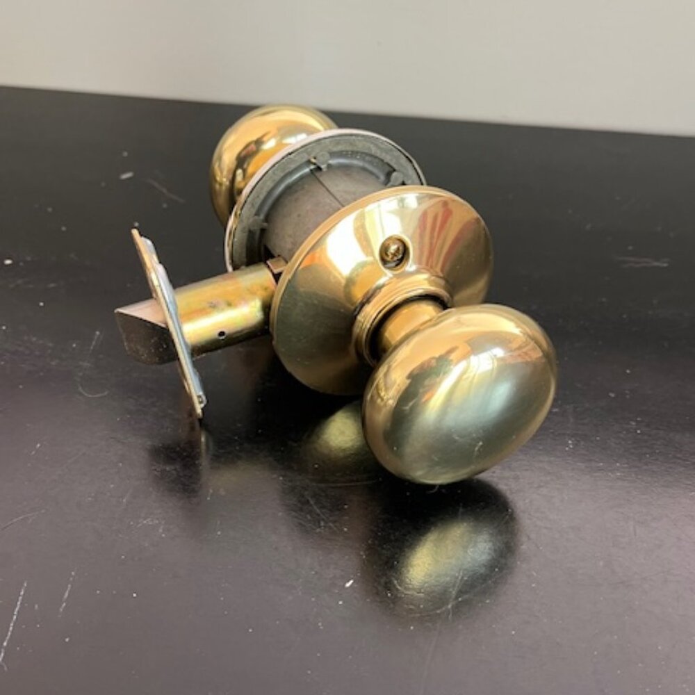 Schlage orbit round passage knob set polished brass
